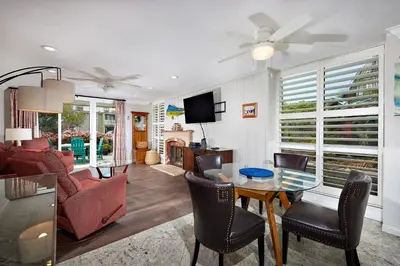 a living room with a table and chairs at Oceanside Beach Condos in Oceanside