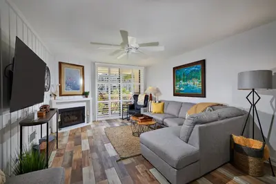 a living room with a couch and a tv at Oceanside Beach Condos in Oceanside