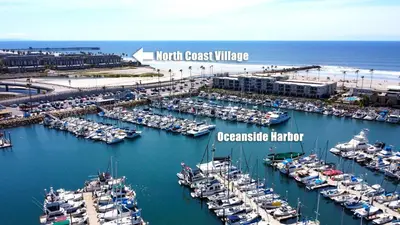 an aerial view of a harbor filled with boats at Oceanside Beach Condos in Oceanside