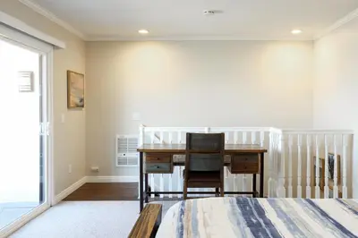 a bedroom with a desk and a bed at Oceanside Beach Condos in Oceanside