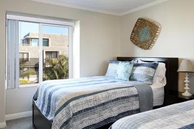 a bedroom with two beds and a window at Oceanside Beach Condos in Oceanside
