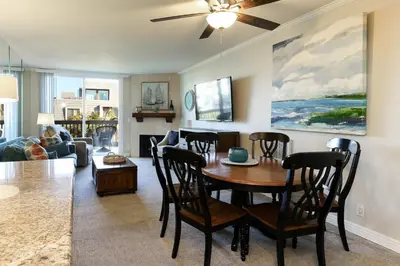 a dining room and living room with a table and chairs at Oceanside Beach Condos in Oceanside