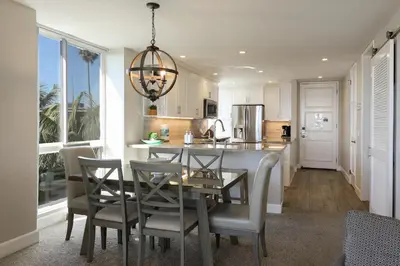 a kitchen and dining room with a table and chairs at Oceanside Beach Condos in Oceanside