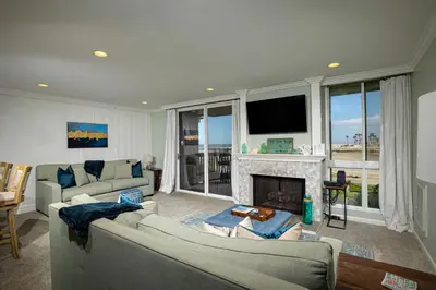 a living room with two couches and a fireplace at Oceanside Beach Condos in Oceanside