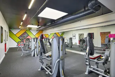 a gym with several tread machines in a room at Oceanside Beach Condos in Oceanside