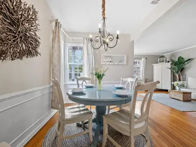 a dining room with a blue table and chairs at Luxury beach home one block from ocean with spa, WiFi, & gorgeous outdoor space in San Diego