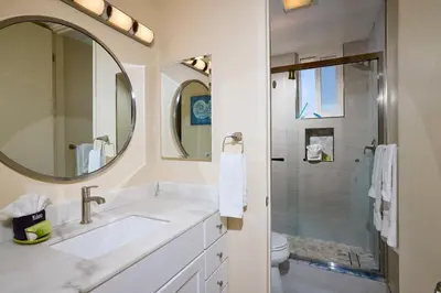 a bathroom with a sink and a shower at Oceanside Beach Condos in Oceanside