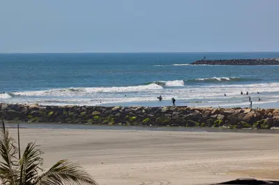a group of people in the water at the beach at Oceanside Beach Condos in Oceanside