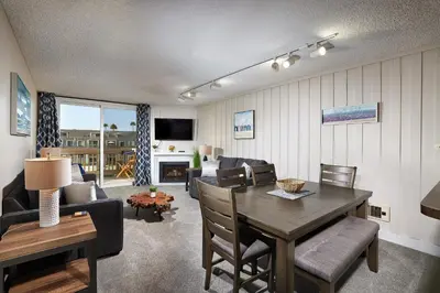 a living room with a table and a dining room at Oceanside Beach Condos in Oceanside