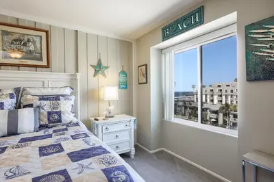 a bedroom with a bed and a window with a view at Oceanside Beach Condos in Oceanside