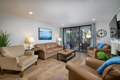 a living room with couches and a fireplace at Oceanside Beach Condos in Oceanside