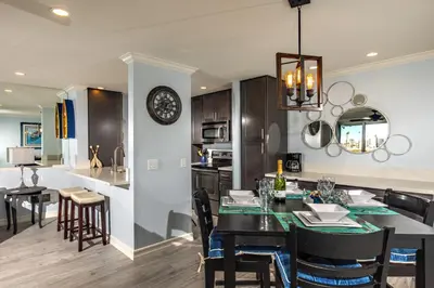 a kitchen and dining room with a table and chairs at Oceanside Beach Condos in Oceanside