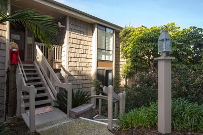 a house with a staircase and a light next to it at Oceanside Beach Condos in Oceanside