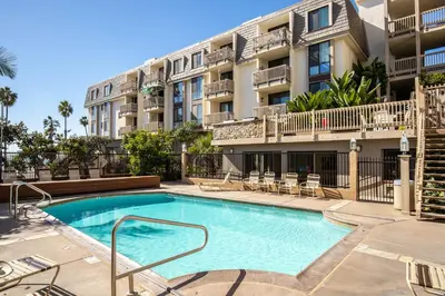 a swimming pool in front of a apartment building at Oceanside Beach Condos in Oceanside