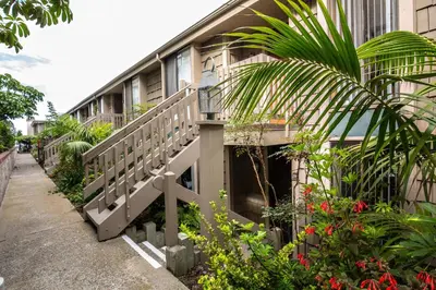 a building with a balcony with plants and flowers at Oceanside Beach Condos in Oceanside