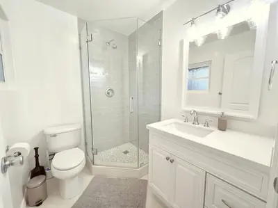 a bathroom with a shower and a toilet and a sink at Historical Beach Bungalow Steps Away From Sand #5 in Newport Beach