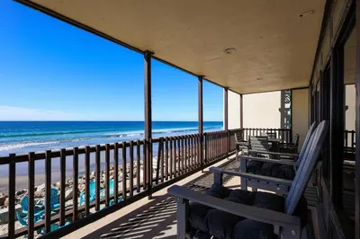a balcony with a view of the beach at Beachfront Retreat in Oceanside