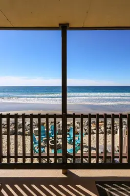 a view of the beach from a balcony at Beachfront Retreat in Oceanside