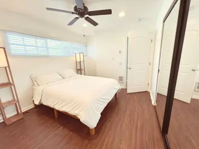 a bedroom with a bed and a ceiling fan at Beach Bungalow #3 in Newport Beach (A/C Included) in Newport Beach