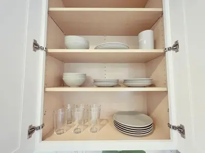 a cupboard filled with plates and bowls and dishes at Beach Bungalow #3 in Newport Beach (A/C Included) in Newport Beach