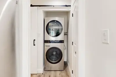 a washer and dryer in a hallway in a house at The Cliffside Bungalow in San Diego