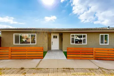 a house with a fence in front of it at The Cliffside Bungalow in San Diego