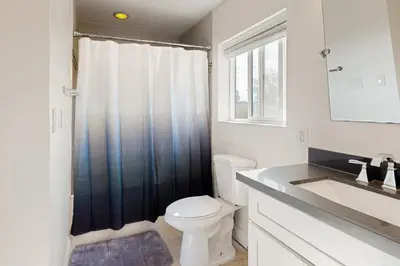 a bathroom with a toilet and a sink at The Cliffside Bungalow in San Diego