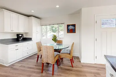 a kitchen with a glass table and chairs at The Cliffside Bungalow in San Diego