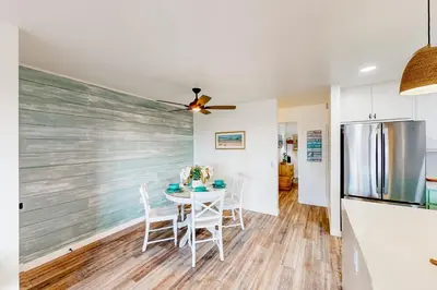 a kitchen and dining room with a table and chairs at Pacific Street Hideaway in Oceanside