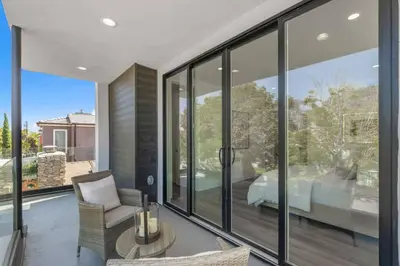 a room with glass windows and a bed on a balcony at Modern, Spacious, home w rooftop view in San Diego