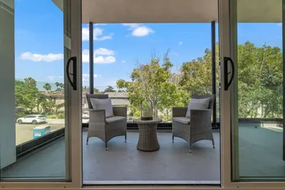 a view from the glass doors of a patio at Modern, Spacious, home w rooftop view in San Diego