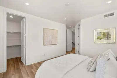 a white bedroom with white walls and a bed at Modern, Spacious, home w rooftop view in San Diego