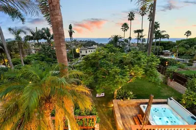 a resort with a pool and palm trees at Casa Solana water views family friendly in Solana Beach