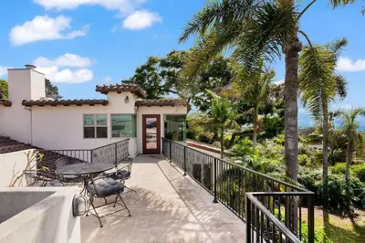 a house with a balcony with a table and chairs at Casa Solana water views family friendly in Solana Beach