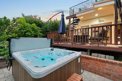 a jacuzzi tub sitting on a patio next to a house at Casa Solana water views family friendly in Solana Beach