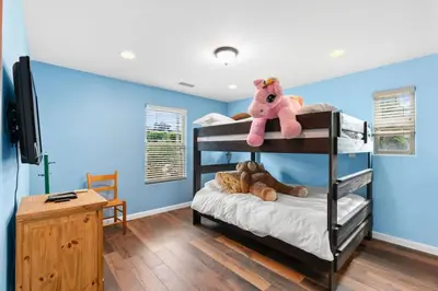 a bedroom with blue walls and bunk beds with stuffed animals at Casa Solana water views family friendly in Solana Beach