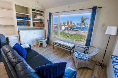 a living room with a couch and a large window at Monthly rental, Coronado Resort Style Town Home in San Diego