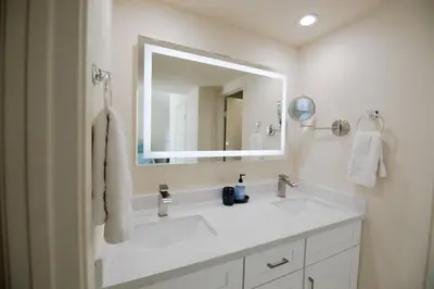 a white bathroom with a sink and a mirror at Monthly rental, Coronado Resort Style Town Home in San Diego