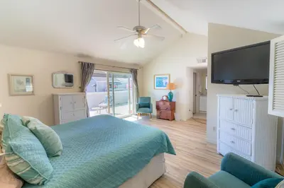 a bedroom with a bed and a flat screen tv at Monthly rental, Coronado Resort Style Town Home in San Diego