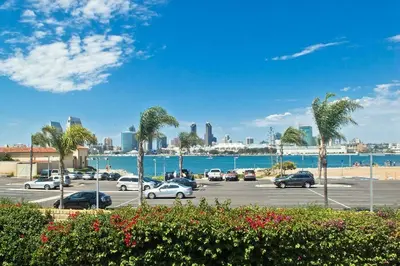 a parking lot with palm trees and the ocean at Monthly rental, Coronado Resort Style Town Home in San Diego