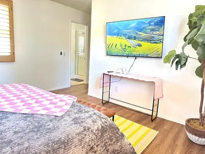 a bedroom with a bed and a desk and a plant at Comfort Retreat 3B3B Villa in Quail Hill Irvine in Irvine
