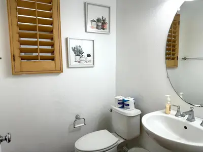 a bathroom with a toilet and a sink and a mirror at Comfort Retreat 3B3B Villa in Quail Hill Irvine in Irvine