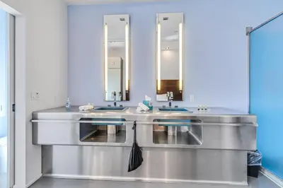 a bathroom with two sinks and two mirrors at The Keating in San Diego