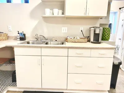 a kitchen with white cabinets and a sink at Urban Oasis near the Zoo A Central Studio for 2 in San Diego