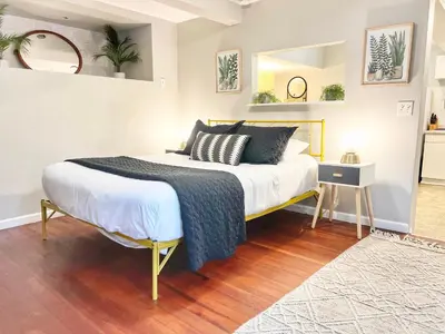 a bedroom with a bed with a blue blanket on it at Urban Oasis near the Zoo A Central Studio for 2 in San Diego