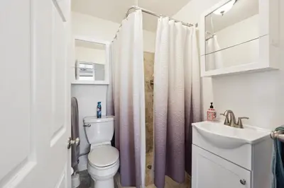 a bathroom with a toilet and a sink at Coastal Haven in Oceanside- Cozy Beach Getaway home in Oceanside