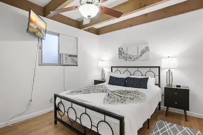 a bedroom with a bed and a ceiling fan at Mission Bay Condo - Steps to Sand, Dining, AC, Parking & Shops! in San Diego
