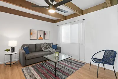 a living room with a couch and a glass table at Mission Bay Condo - Steps to Sand, Dining, AC, Parking & Shops! in San Diego