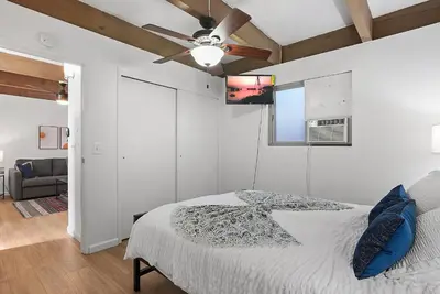 a bedroom with a bed and a ceiling fan at Mission Bay Condo - Steps to Sand, Dining, AC, Parking & Shops! in San Diego