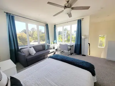 a living room with a bed and a couch at Upscale Modern Townhouse at Balboa Park in San Diego